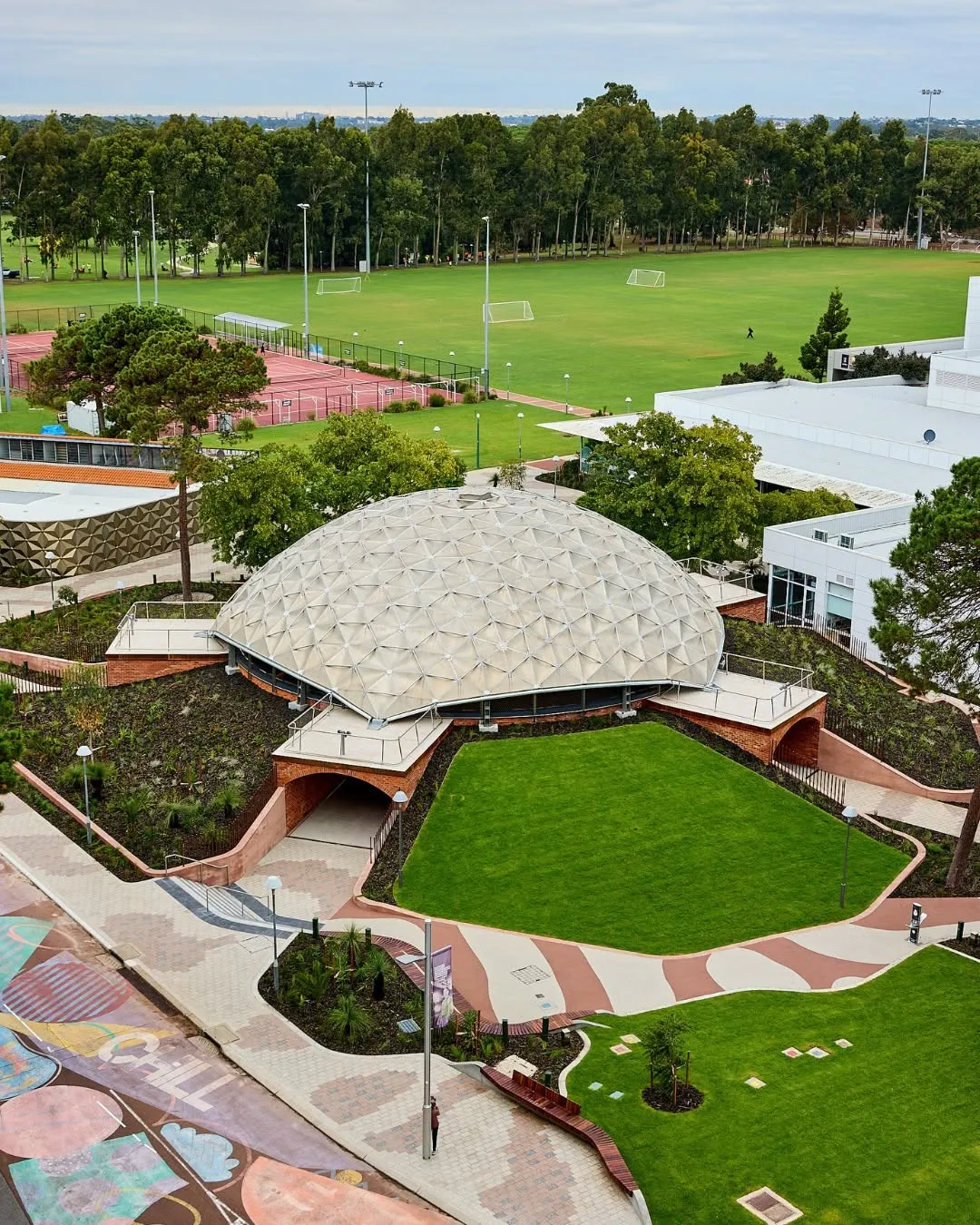 Meet your old-new favourite spot on campus ✨
 
At the heart of our Bentley campus, the Dome has just been transformed into a beautiful space where you can enjoy campus life.
 
With new footpaths, seating and a modern design, it’s now an even better place to take a break between classes, catch up with friends and reset during busy days.
 
It’ll also host events, giving you more opportunities to connect with new people and get involved beyond the classroom. 
 
While the space has been refreshed, it remains grounded in the history of the land itself. The Dome sits at the intersection of the Whadjuk Noongar Songlines ‘Kujal Kela’ (Twin Dolphin) and ‘Djiridji’ (Zamia). The design recognises and respects the importance of place 💛
 
Check it out next time you’re on campus.
 
📷 SoCo Studios
 
#CurtinUniversity #CurtinLife CRICOS code: 00301J.