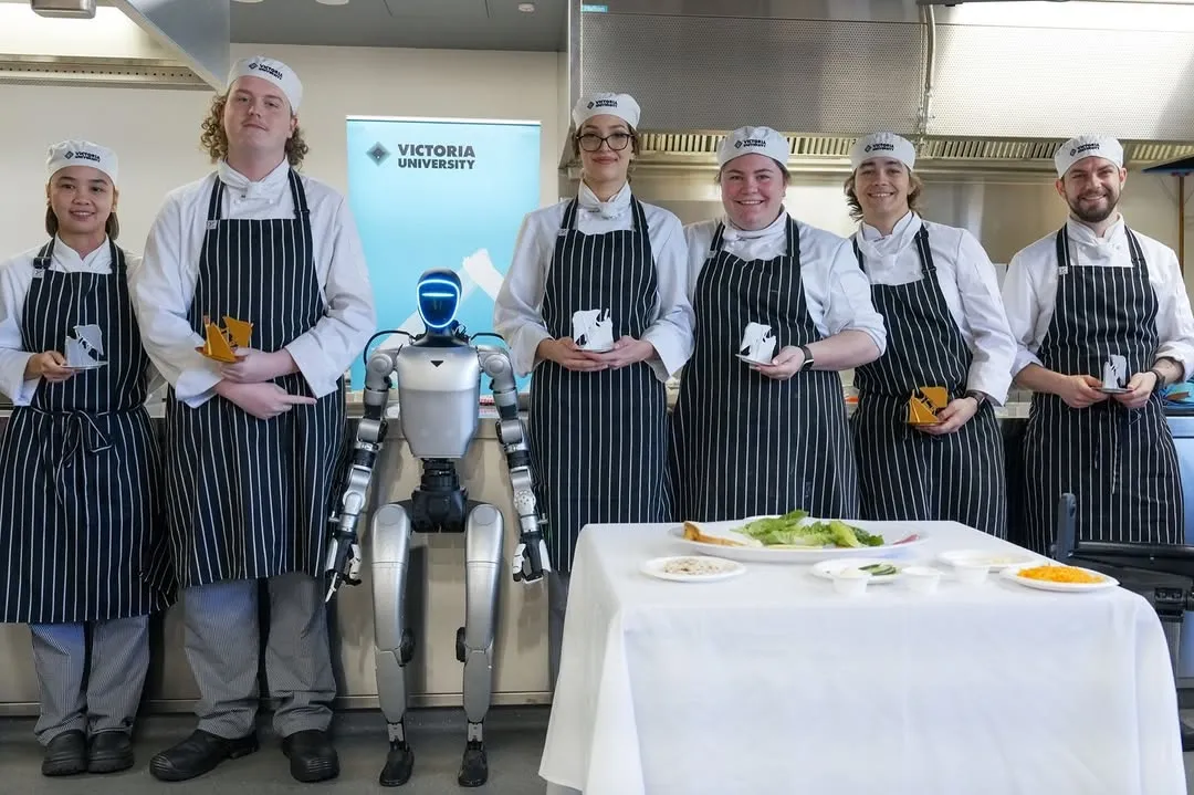 Have you ever made a sandwich with a robot? 🤖

Our hospitality students recently welcomed a new chef to the kitchen, Jetson, A GI humanoid robot from VU’s Brimbank Tech School, where they partook in a sandwich-making competition. 

While Jetson excelled in presentation with his custom jacket and chef’s hat, his sandwich did not compute with the judges.

Congratulations to students Hugo Garrett & Henry Deller, who were crowned kings of the sandwich & presented with toastie trophies.🧀🏆

Humanity remains undefeated... at least until the robots perfect the ultimate toastie.
